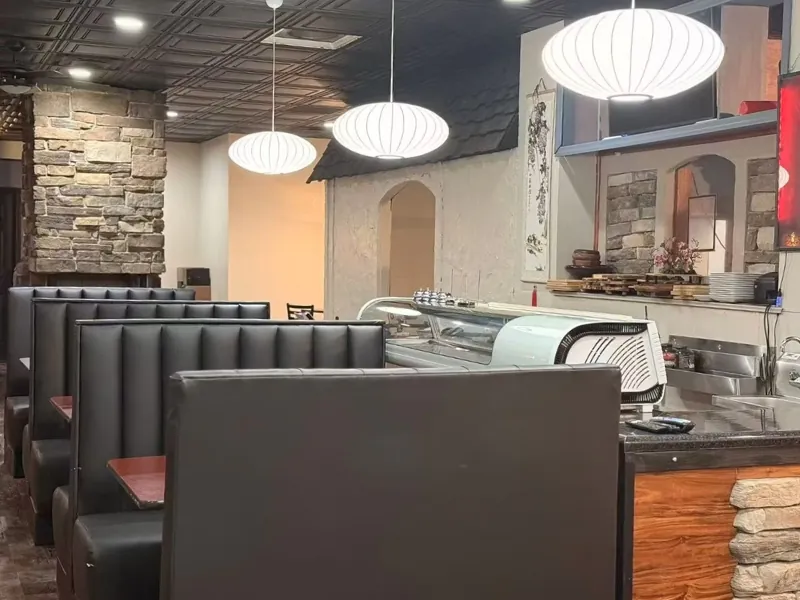 Sushi bar area with booth seating and stone accents at Osaka Ripley, a Japanese Restaurant in Ripley